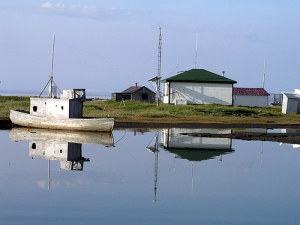 Herschel Island, a quiet pond, an old fishing boat, the old Canadian Signal Corps building--amazing photo by incredible photographer Hank Moorlag